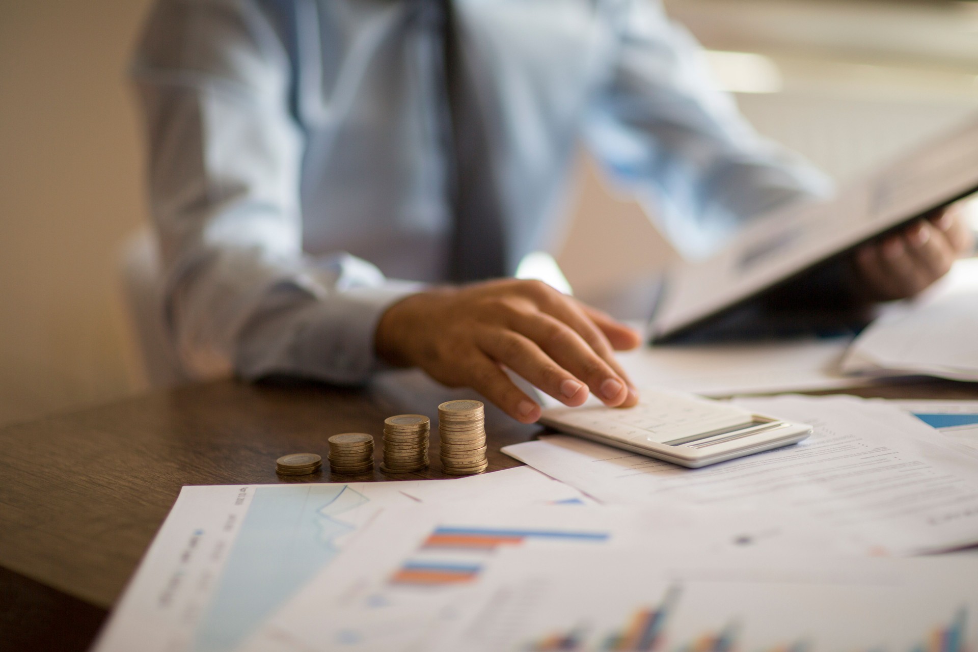 Business accounting concept, Business man using calculator with computer laptop, budget and loan paper in office.